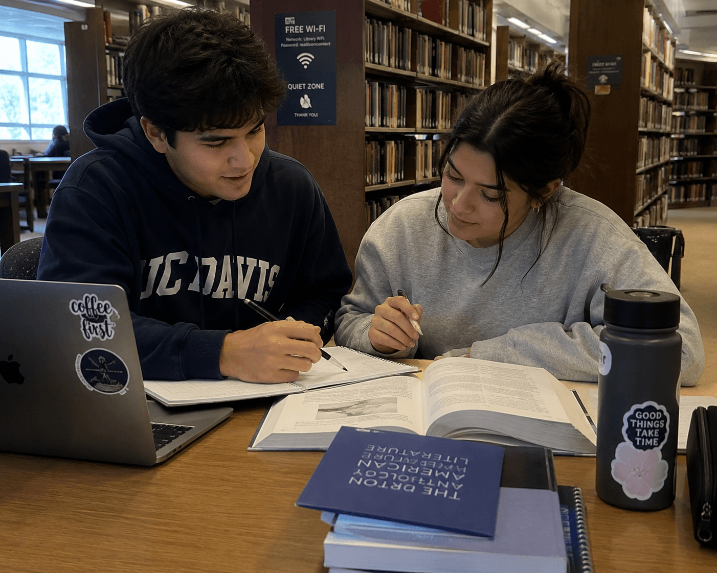 Two students studying together in the library